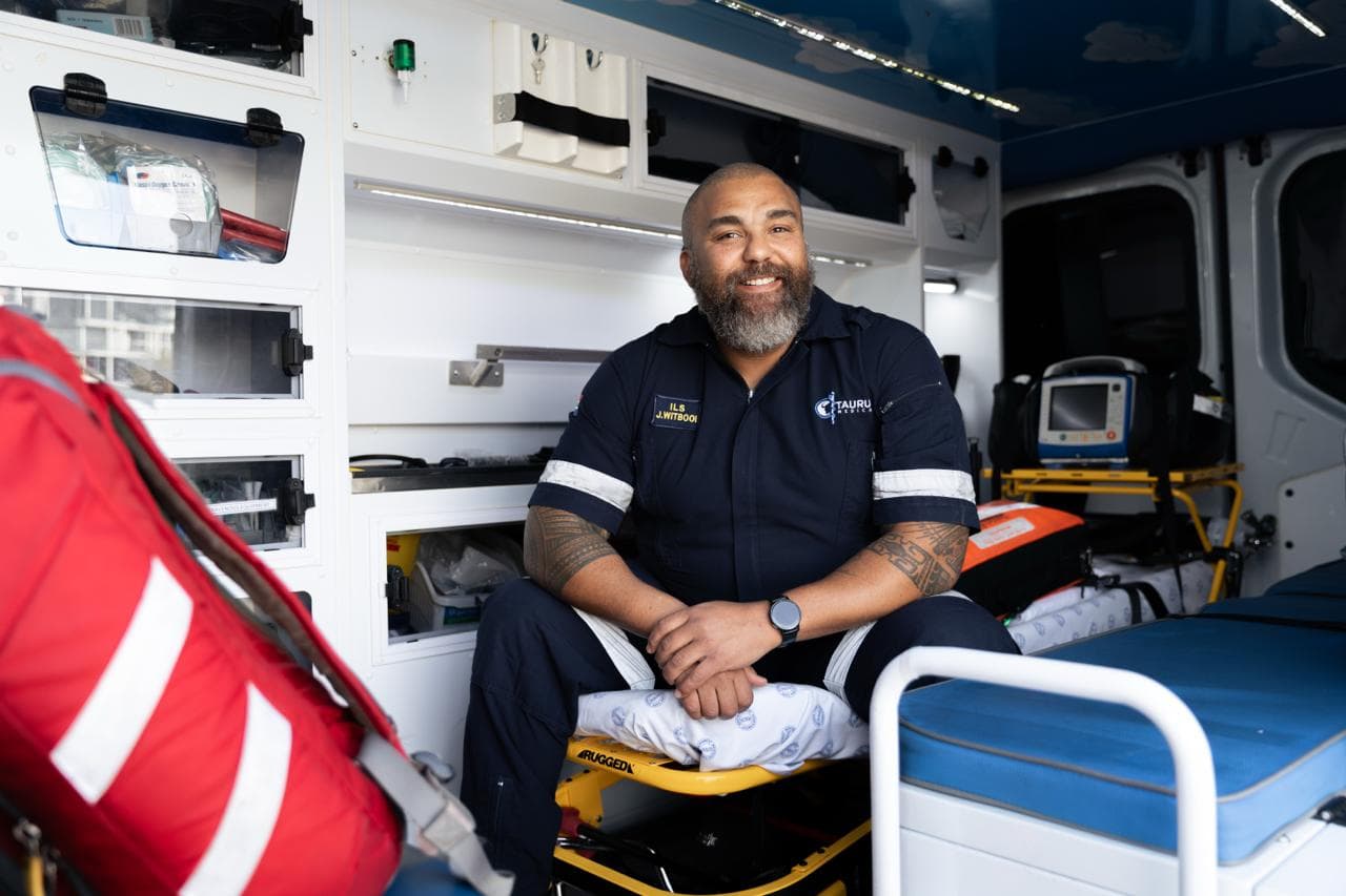 Taurus ILS paramedic seated on the stretcher in a fully equipped ambulance